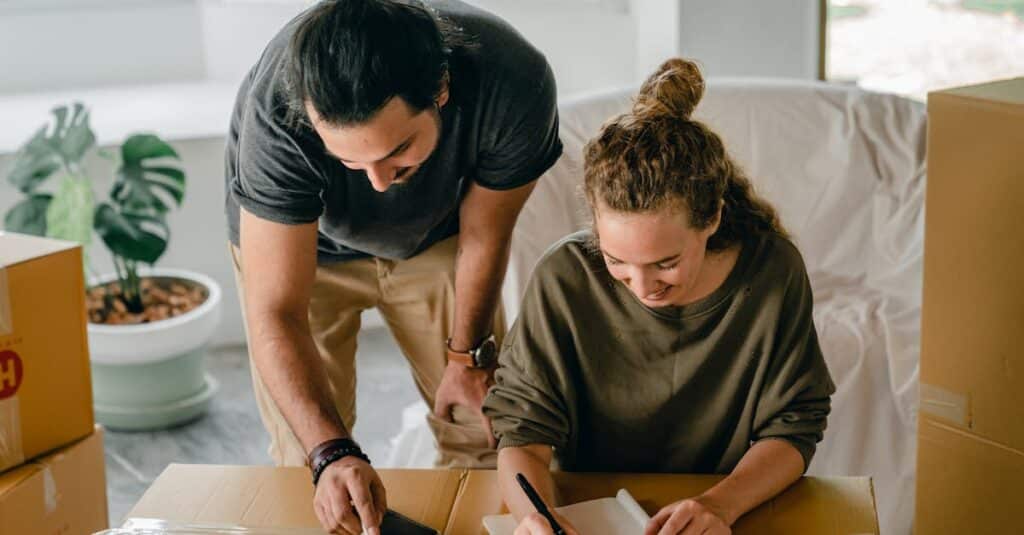 a-cheerful-couple-organizing-their-move-into-a-new-home-surrounded-by-boxes-and-notes