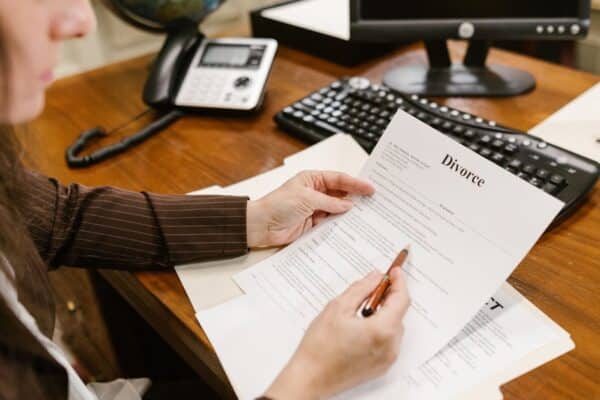 a-lawyer-examines-divorce-documents-at-a-desk-in-a-law-office-setting-emphasizing-professionalism - Adam C. Gynac & Associates LLC Paternity Attorney Services | Adam C Gynac Associates LLC Joliet IL Page 4