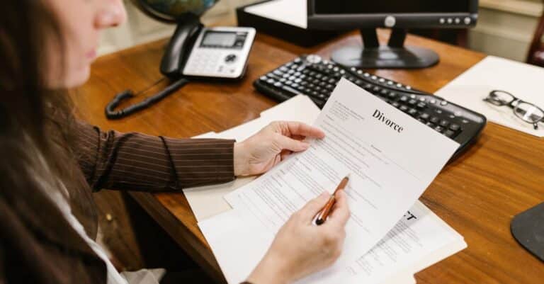 a-lawyer-examines-divorce-documents-at-a-desk-in-a-law-office-setting-emphasizing-professionalism - Adam C. Gynac & Associates LLC Paternity Attorney Services | Adam C Gynac Associates LLC Joliet IL