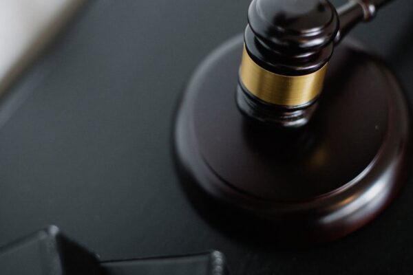 close-up-of-a-wooden-judge-s-gavel-on-a-black-desk-symbolizing-justice-and-law - Adam C. Gynac & Associates LLC How to Handle Probate During the Holidays A Practical Guide for Executors and Families Adam C Gynac Associates LLC
