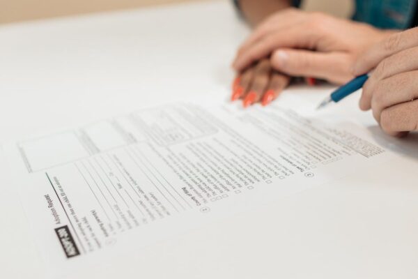 close-up-of-hands-signing-adoption-papers-in-an-office-environment-symbolizing-family-and-legal-pro - Adam C. Gynac & Associates LLC Child Support Attorneys | Adam C Gynac Associates LLC Joliet IL Page 5
